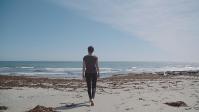 Lone woman walking on a beach